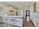 Bright kitchen with white cabinets, a center island, stainless steel appliances, and bar stool seating at 605 St. Charles Pl, Fayetteville, GA 30215