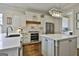Stylish kitchen with white cabinets, stainless steel appliances, and marble countertops at 605 St. Charles Pl, Fayetteville, GA 30215