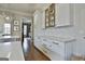 Elegant kitchen with white cabinets, stainless steel appliances, marble countertops, and an open layout at 605 St. Charles Pl, Fayetteville, GA 30215