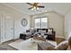 Comfortable living room featuring a large sectional sofa, ceiling fan and natural light at 605 St. Charles Pl, Fayetteville, GA 30215