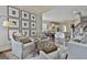 Open concept living room flows into kitchen and features stylish decor and hardwood floors at 605 St. Charles Pl, Fayetteville, GA 30215