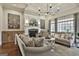 Cozy living room featuring a fireplace, hardwood floors, and stylish furniture at 605 St. Charles Pl, Fayetteville, GA 30215