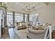 Bright living room featuring large windows, fireplace, and elegant furnishings at 605 St. Charles Pl, Fayetteville, GA 30215