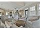 Bright living room is open to the entryway and features hardwood floors and comfortable seating at 605 St. Charles Pl, Fayetteville, GA 30215