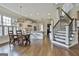 Spacious open-concept living space featuring a dining area, kitchen with island, and a staircase at 605 St. Charles Pl, Fayetteville, GA 30215