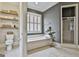 Bathroom features soaking tub, shutters, storage shelves, and a walk-in shower at 605 St. Charles Pl, Fayetteville, GA 30215