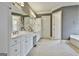 Large bathroom with dual vanities, linen closet, and decorative silver vase at 605 St. Charles Pl, Fayetteville, GA 30215