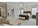 Spacious main bedroom features a king-size bed, sitting area, and access to the ensuite at 605 St. Charles Pl, Fayetteville, GA 30215