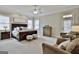 Spacious main bedroom with a king-size bed, sitting area, and large windows at 605 St. Charles Pl, Fayetteville, GA 30215