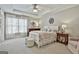 Bright main bedroom features tray ceiling, white wood bed frame and neutral decor at 605 St. Charles Pl, Fayetteville, GA 30215