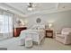 Bright main bedroom features tray ceiling, white wood bed frame and neutral decor at 605 St. Charles Pl, Fayetteville, GA 30215