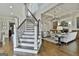 Elegant staircase leading to a cozy living room with a fireplace and stylish decor at 605 St. Charles Pl, Fayetteville, GA 30215