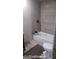 Bathroom featuring a new white tub and toilet set against cement board walls at 4571 Scarborough Rd, South Fulton, GA 30349