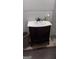 Elegant vanity with an undermount sink and dark wood cabinetry, offering classic style and ample storage at 4571 Scarborough Rd, South Fulton, GA 30349