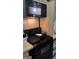 A black appliance set of a microwave and oven sit atop wooden countertops in a kitchen ready for renovation at 4571 Scarborough Rd, South Fulton, GA 30349