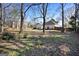 Spacious backyard with a wooden fence, mature trees and a well-maintained lawn at 3434 Estels Ln, Conyers, GA 30013