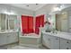 Bright bathroom with double sinks, vanity and corner soaking tub at 3434 Estels Ln, Conyers, GA 30013