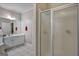 Bright bathroom featuring tile floors, sleek vanity, framed mirror, and glass-enclosed shower at 3434 Estels Ln, Conyers, GA 30013