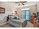 Bedroom with queen-sized bed, blue bedding, ceiling fan, and wood dressers at 3434 Estels Ln, Conyers, GA 30013