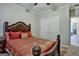 Bedroom featuring decorative headboard, red pillows and covers, and white closet doors at 3434 Estels Ln, Conyers, GA 30013