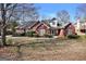 Charming red brick home featuring mature landscaping and classic architectural details at 3434 Estels Ln, Conyers, GA 30013