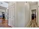 Interior hallway featuring hardwood and laminate floors, leading to other rooms at 3434 Estels Ln, Conyers, GA 30013