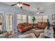 Cozy living room featuring comfortable sofas, patterned rug, ceiling fans, and neutral tones at 3434 Estels Ln, Conyers, GA 30013