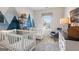This playful Bedroom showcases dual cribs, modern decor, and a calming accent wall at 10459 Trellis Lane (Lot 27), Hampton, GA 30228