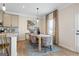 Elegant dining room with a wooden table, stylish chairs, and modern light fixture at 10459 Trellis Lane (Lot 27), Hampton, GA 30228