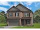 Charming two-story brick home with a two-car garage and classic architectural details at 10459 Trellis Lane (Lot 27), Hampton, GA 30228