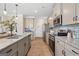 Open-concept kitchen featuring modern appliances and a view of the dining area at 10459 Trellis Lane (Lot 27), Hampton, GA 30228