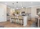 Modern kitchen island with granite countertops, barstool seating, and stainless steel appliances at 10459 Trellis Lane (Lot 27), Hampton, GA 30228