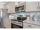Modern kitchen with stainless steel appliances and granite countertops at 10459 Trellis Lane (Lot 27), Hampton, GA 30228