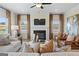 Cozy living room with fireplace, large windows, and modern decor at 10459 Trellis Lane (Lot 27), Hampton, GA 30228