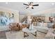 Bright living room features an open concept design, modern furniture, and a ceiling fan at 10459 Trellis Lane (Lot 27), Hampton, GA 30228