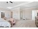 Relax in this neutral-toned main bedroom, complete with cozy sitting area, plush carpet, and adjoining bathroom at 10459 Trellis Lane (Lot 27), Hampton, GA 30228