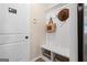 Convenient mudroom includes a built-in bench, storage, and coat hooks at 10459 Trellis Lane (Lot 27), Hampton, GA 30228