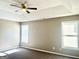 Bedroom features two windows, neutral paint, a ceiling fan, and grey carpet at 3497 Thornewoode Pointe, Decatur, GA 30034
