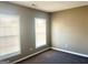 Bedroom featuring neutral paint and carpet, plus two large windows with blinds at 3497 Thornewoode Pointe, Decatur, GA 30034