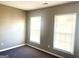 Bedroom featuring two windows, neutral paint and gray carpet at 3497 Thornewoode Pointe, Decatur, GA 30034