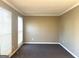 Bedroom featuring two windows, neutral paint and grey carpet at 3497 Thornewoode Pointe, Decatur, GA 30034