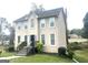 Two-story home with neutral siding, complemented by manicured landscaping, and steps leading to the front door at 3497 Thornewoode Pointe, Decatur, GA 30034