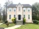 Two-story home showcasing a black front door, and a well-manicured lawn and shrubbery at 3497 Thornewoode Pointe, Decatur, GA 30034