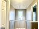 Upstairs hallway with neutral paint and a light fixture hanging in front of a window at 3497 Thornewoode Pointe, Decatur, GA 30034