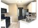 Kitchen with white cabinets, black appliances, tile flooring, and a window view at 3497 Thornewoode Pointe, Decatur, GA 30034