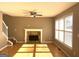 Sunlit living room featuring a fireplace, hardwood floors, and a ceiling fan at 3497 Thornewoode Pointe, Decatur, GA 30034