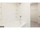 White tiled shower and separate walk-in closet at 147 Avondale Blvd, Conyers, GA 30013