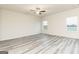 Spacious living room with modern gray wood-look flooring and ceiling fan at 147 Avondale Blvd, Conyers, GA 30013