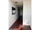 Hallway featuring hardwood floors and a large mirror, offering a welcoming entrance at 10467 Tara Beach Cir, Jonesboro, GA 30238