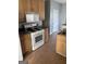 Well-lit kitchen with wooden cabinets and modern appliances at 10467 Tara Beach Cir, Jonesboro, GA 30238